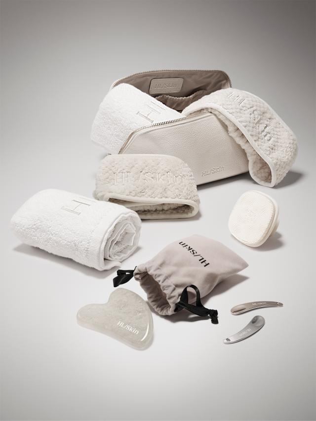 Collection of white and gray travel accessories on a light gray background