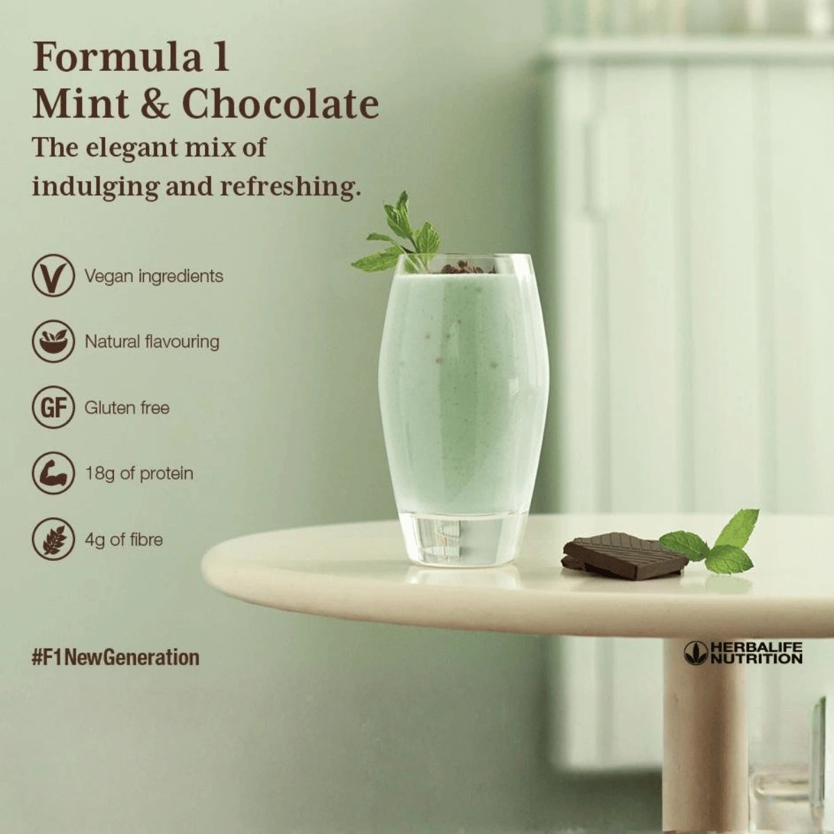 Glass of mint and chocolate shake on a table with Herbalife Nutrition branding.
