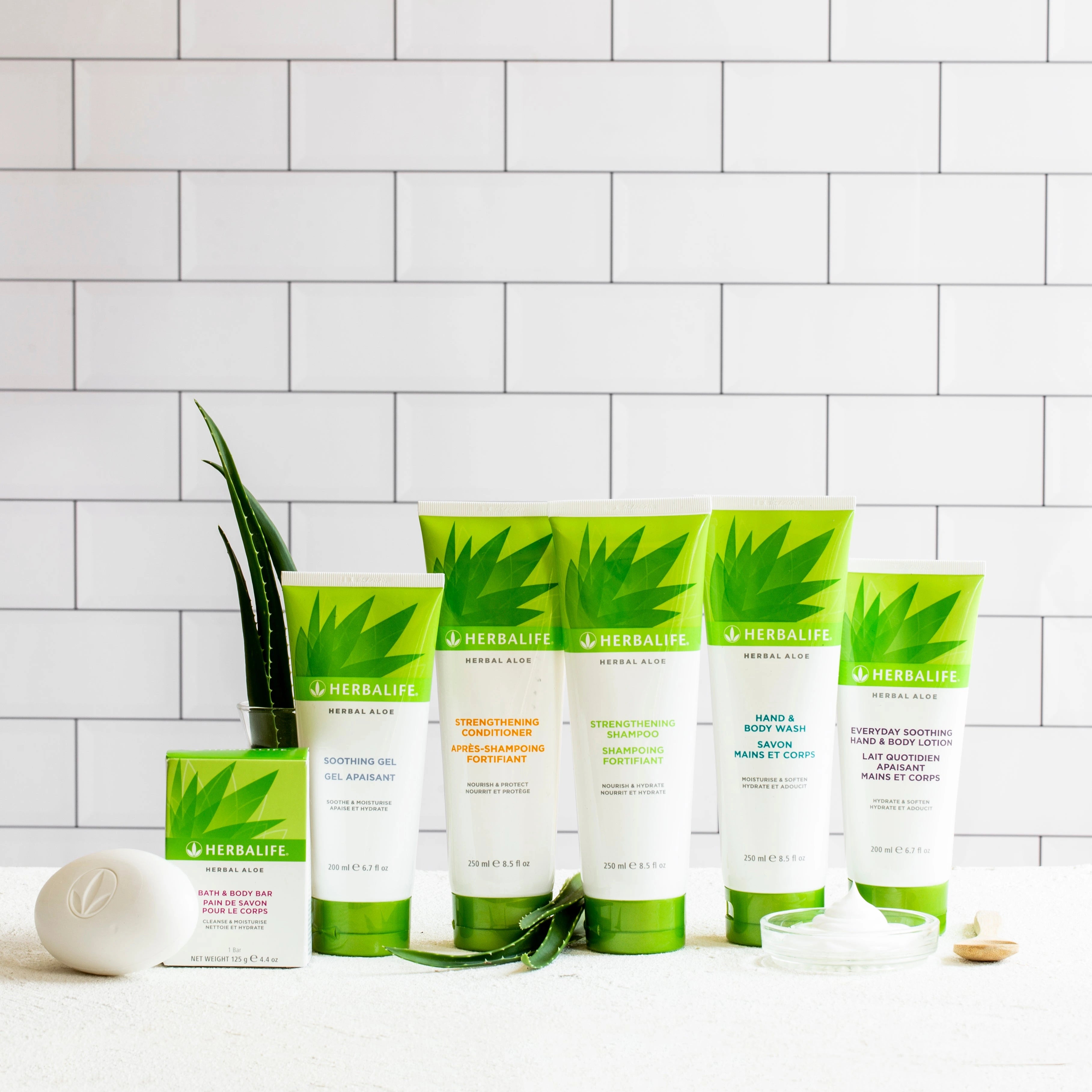 Herbalife skincare products on a white surface with a tiled wall background